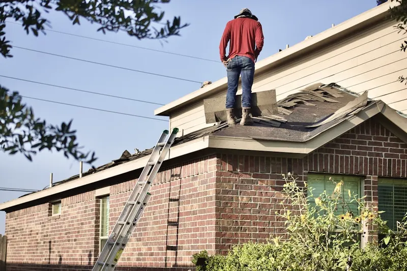 Professional roofer working on a residential roof in Meadowland
